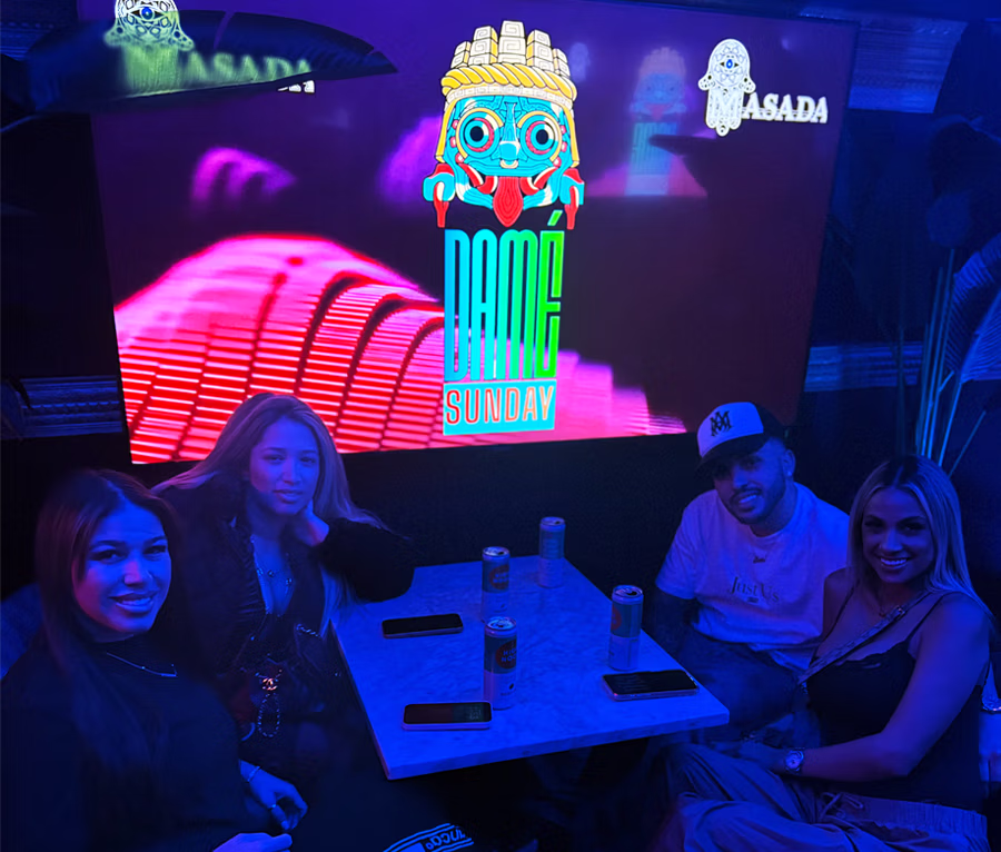Guests seated beneath the DAMÉ Sunday display at Masada Nightclub